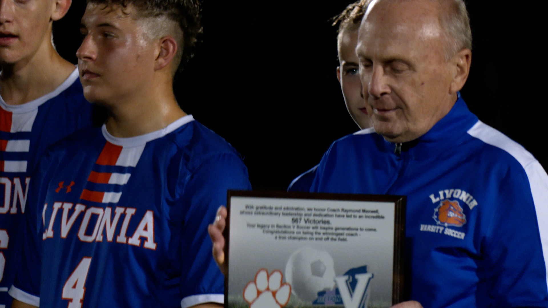 Livonia boy's soccer coach Ray Maxwell holds plaque commemorating his record breaking win in Section V boy's soccer